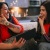 a couple of women sitting on a couch and laughing