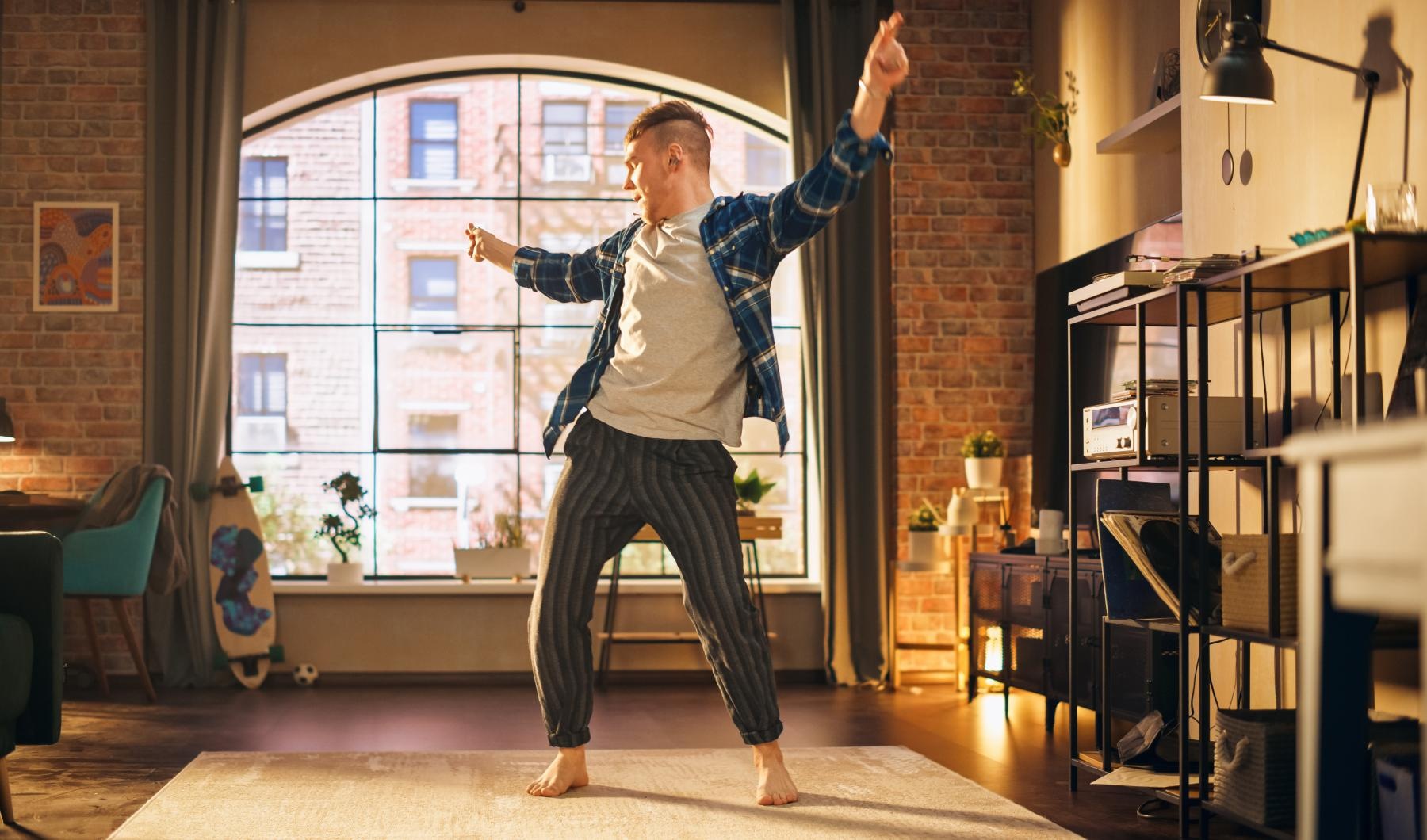 a man dancing in a room in his pajamas