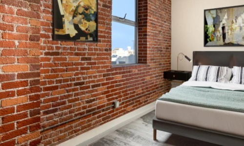 bed next to window in bedroom