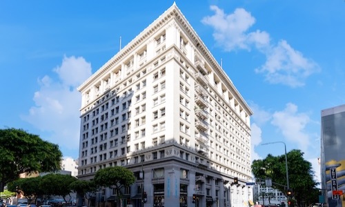 a white multi-storied. building with many windows