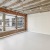 living room with large windows and a brick wall