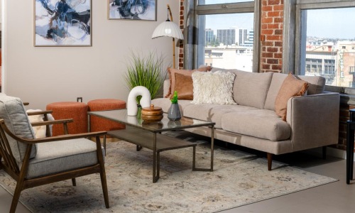 a living room with a couch and chairs